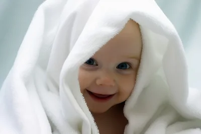 Happy Baby Wrapped In A Soft White Towel