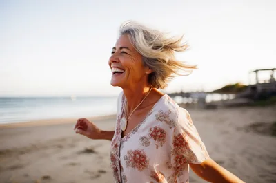 Happy Mature Woman Laughing On A Sunny Beach