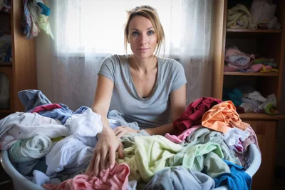 Woman Sorting Laundry In A Home Setting