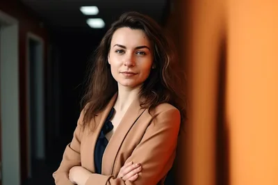 Professional Woman Standing In A Modern Office Hallway
