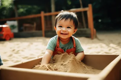 Happy Toddler Playing In A Sandbox