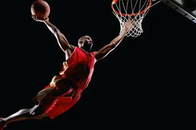 Professional Basketball Player Performing A Powerful Slam Dunk