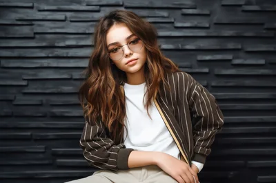 Young Woman Wearing Glasses And Striped Jacket