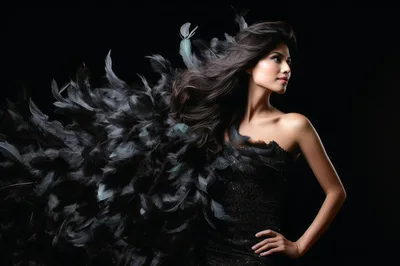 Elegant Woman Posing With Black Feathers