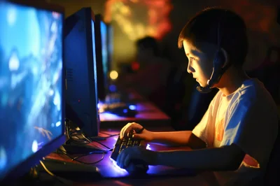 Young Boy Playing Video Games In A Dark Room