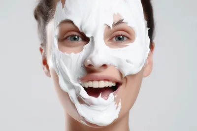 Young Woman With White Facial Mask Smiling
