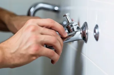 Plumber Installing Or Repairing A Wall Mounted Faucet