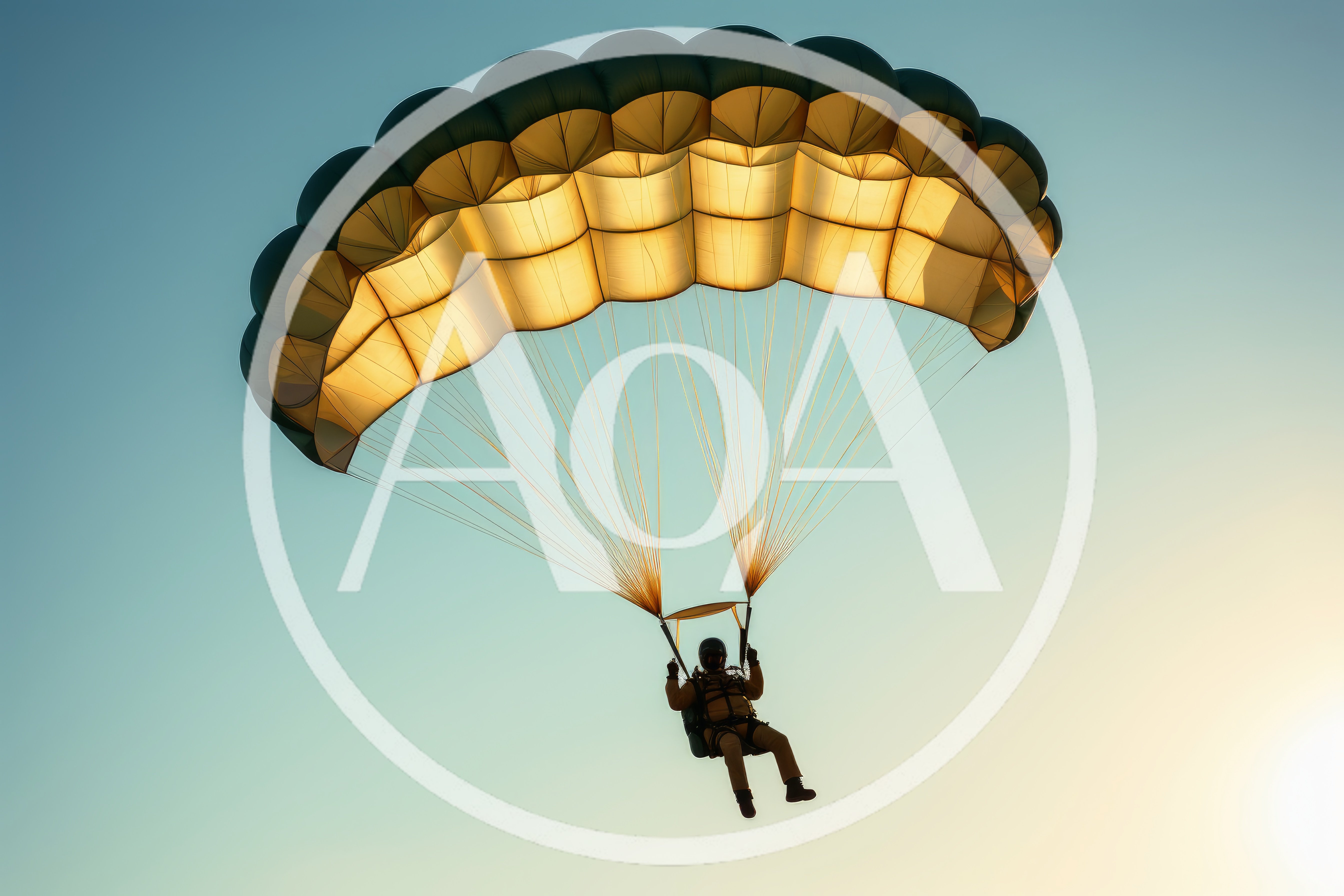 Skydiver Descending With Open Parachute Against Clear Sky