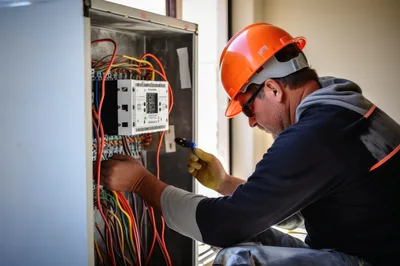 Electrician Working On Industrial Electrical Control Panel