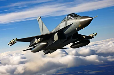 Modern Fighter Jet Flying Above Clouds