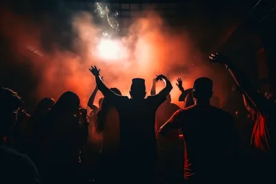 Crowd Dancing at a Nightclub with Red Stage Lighting