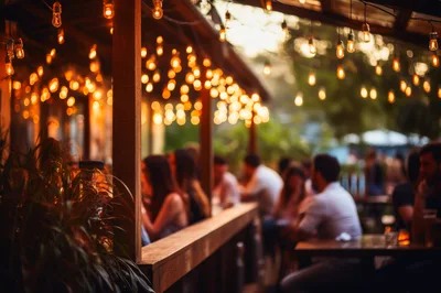 People Socializing at an Outdoor Restaurant Patio at Night