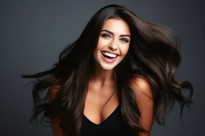 Portrait Of A Smiling Woman With Flowing Dark Hair