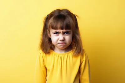 Portrait Of A Grumpy Little Girl In Yellow