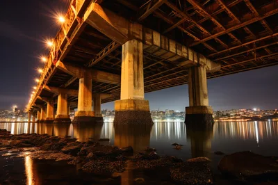Night View Underneath A Large Steel Bridge