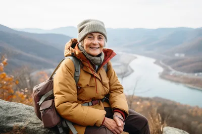 Senior Woman Hiking Resting On A Mountain Overlook