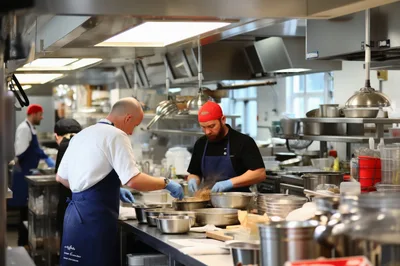 Professional Chefs Preparing Food In A Commercial Kitchen