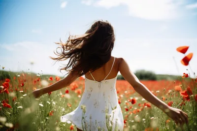 Young Woman Running Through A Vibrant Poppy Field