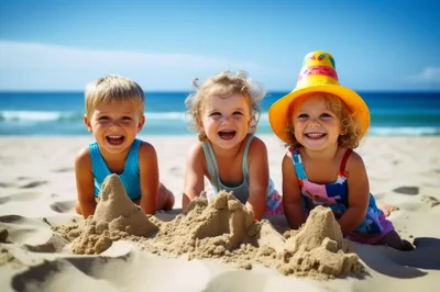 Three Happy Toddlers Playing With Sand On The Beach
