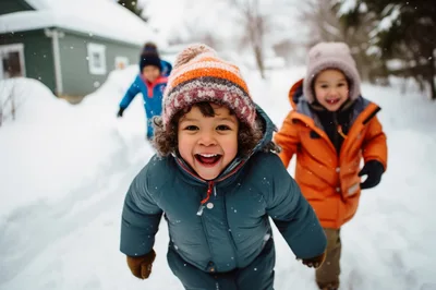 Happy Children Playing Outdoors In The Snow
