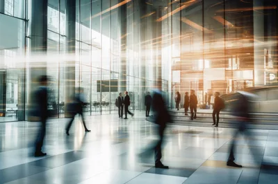 Business Professionals Walking Through Modern Glass Office Lobby