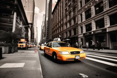 Yellow Taxi Cab Driving Down New York City Street