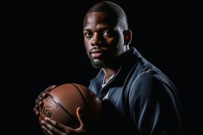 Portrait Of A Focused Basketball Player Holding A Ball