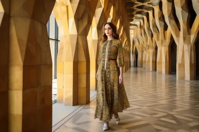 Elegant Woman Walking Through Modern Architectural Hallway
