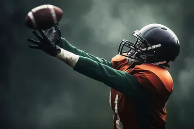 American Football Player Catching A Football