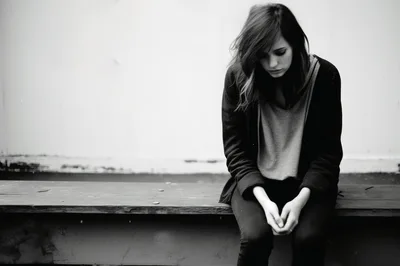 Sad Young Woman Sitting Alone Outdoors