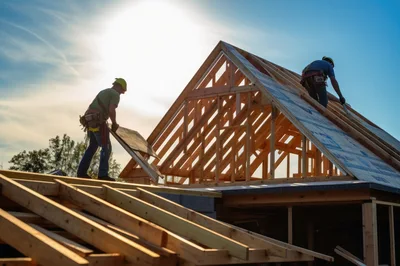 Construction Workers Installing Plywood Roof Sheathing