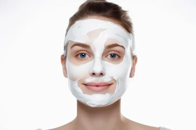 Young Woman Applying White Facial Mask