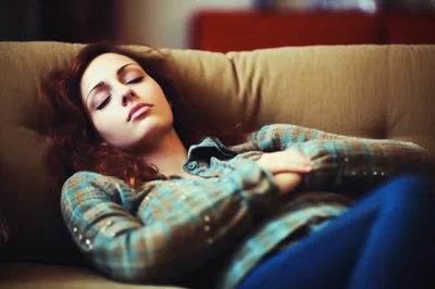 Young Woman Sleeping Peacefully On A Comfortable Sofa