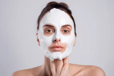 Young Woman Applying White Facial Mask
