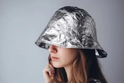 Young Woman Wearing A Shiny Metallic Bucket Hat