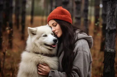 Young Woman Hugging Her Fluffy White Dog In Forest