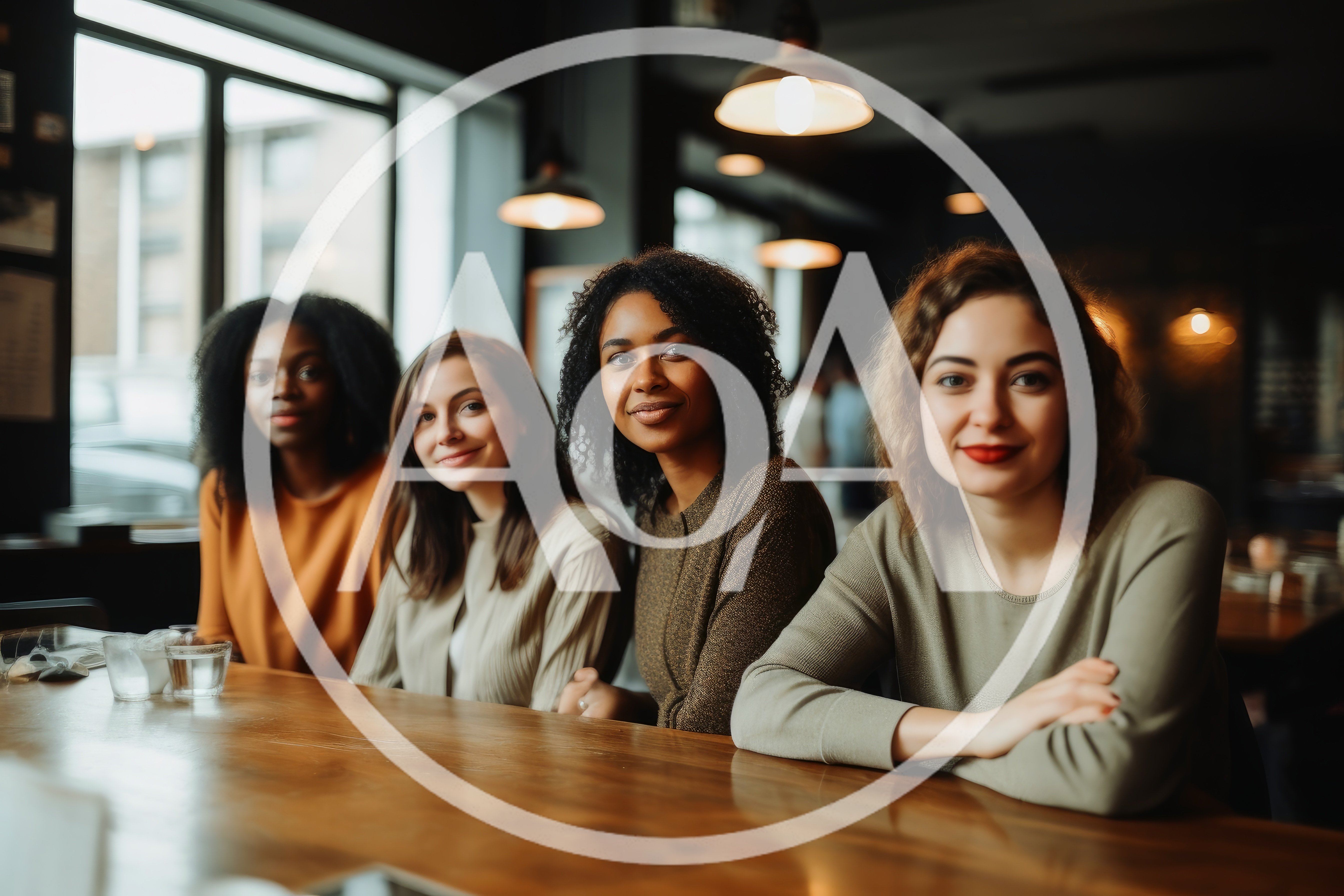 Four Diverse Women Sitting Together At A Cafe Table