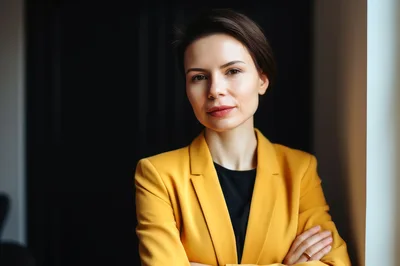 Professional Businesswoman In Yellow Blazer Standing In Office