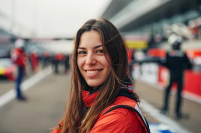 Smiling Female Race Car Driver At The Pit Lane