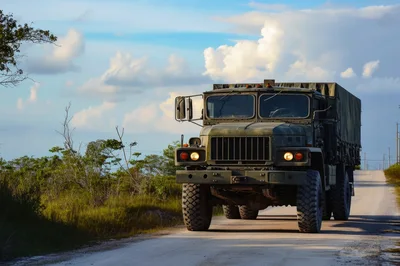 Military Cargo Truck Driving on Rural Road