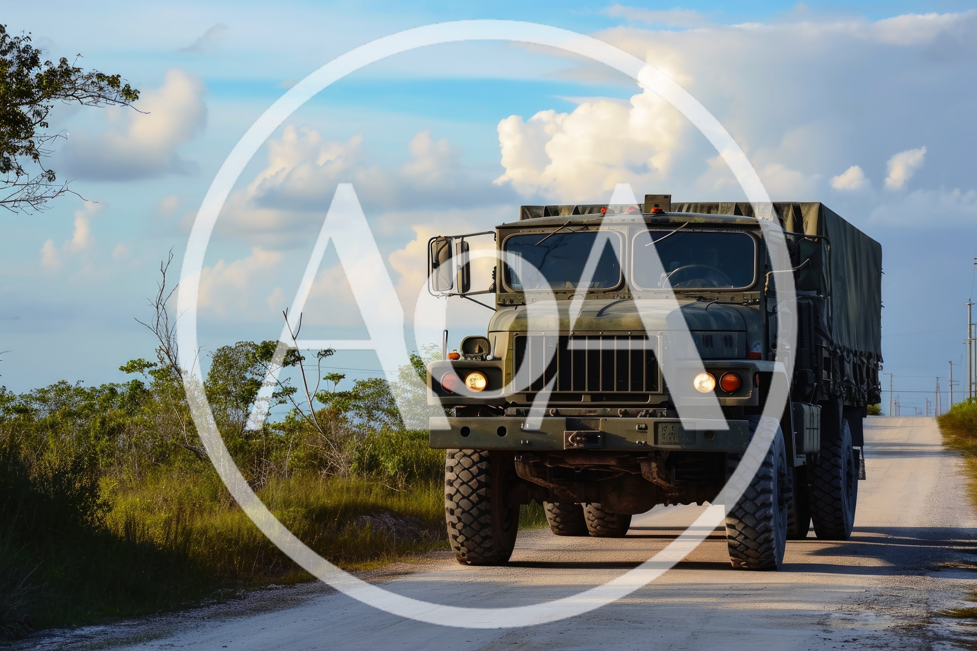 Military Cargo Truck Driving on Rural Road