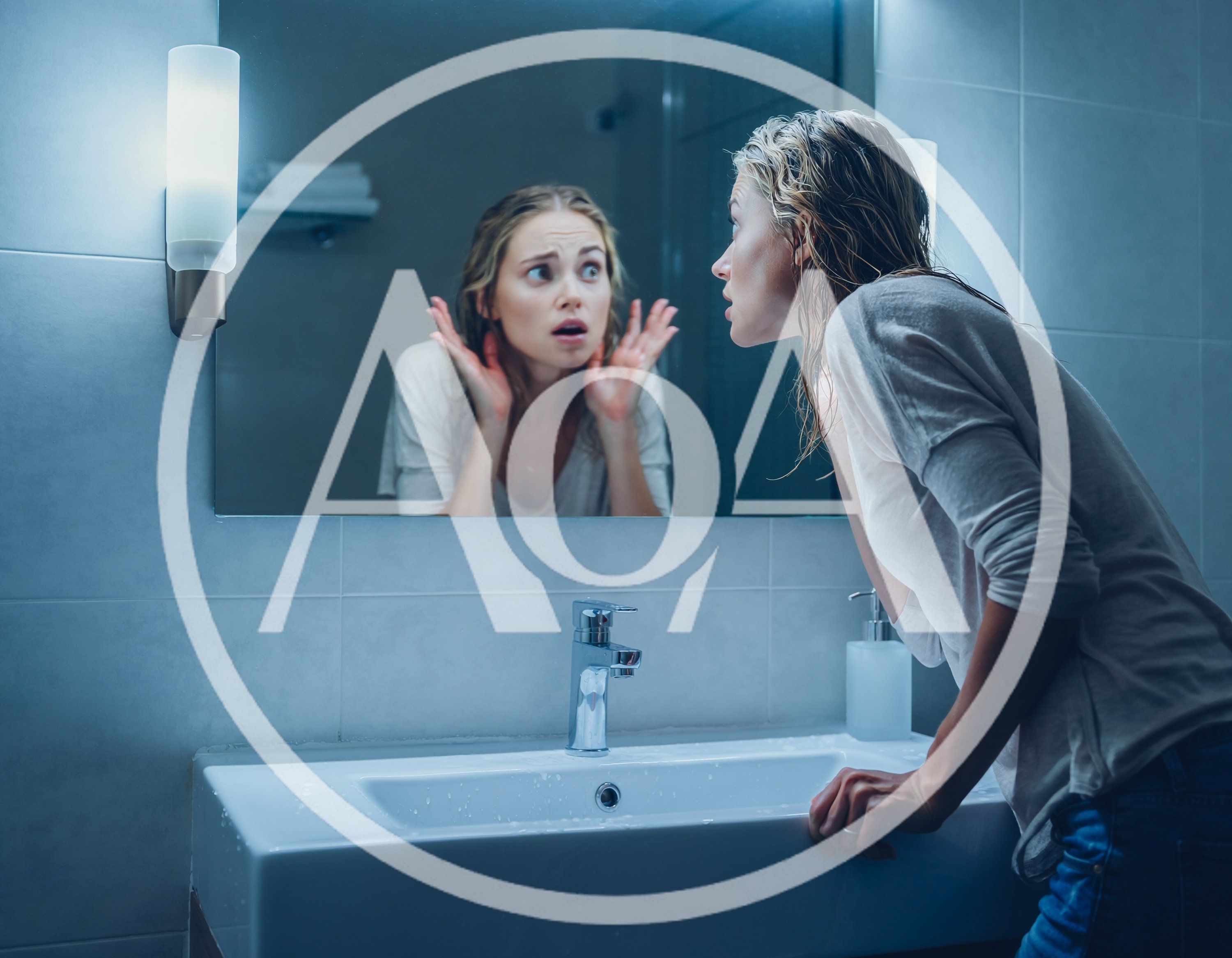 Stressed Woman Looking At Her Reflection In Bathroom Mirror