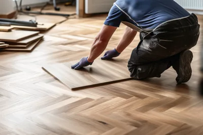 Professional Flooring Installer Laying Herringbone Wood Planks