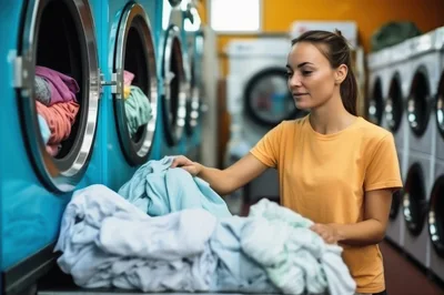Young Woman Sorting Laundry In A Laundromat