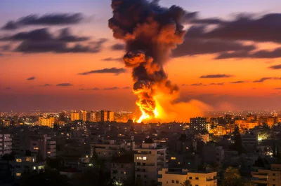 Massive Explosion Over City Skyline At Sunset