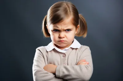 Angry Little Girl With Pigtails Crossing Her Arms