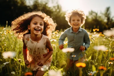 Happy Children Running Through A Sunny Wildflower Meadow