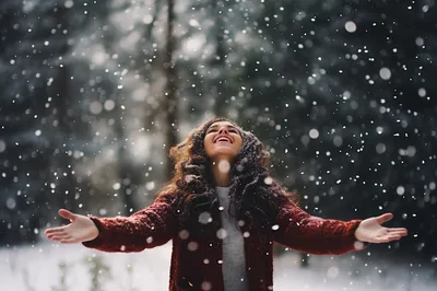Happy Woman Enjoying Snowfall In Winter Forest