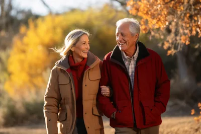 Senior Couple Walking Together in Autumn Forest