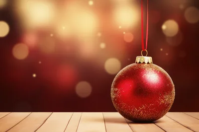 Red Christmas Ornament Hanging Over Wooden Surface